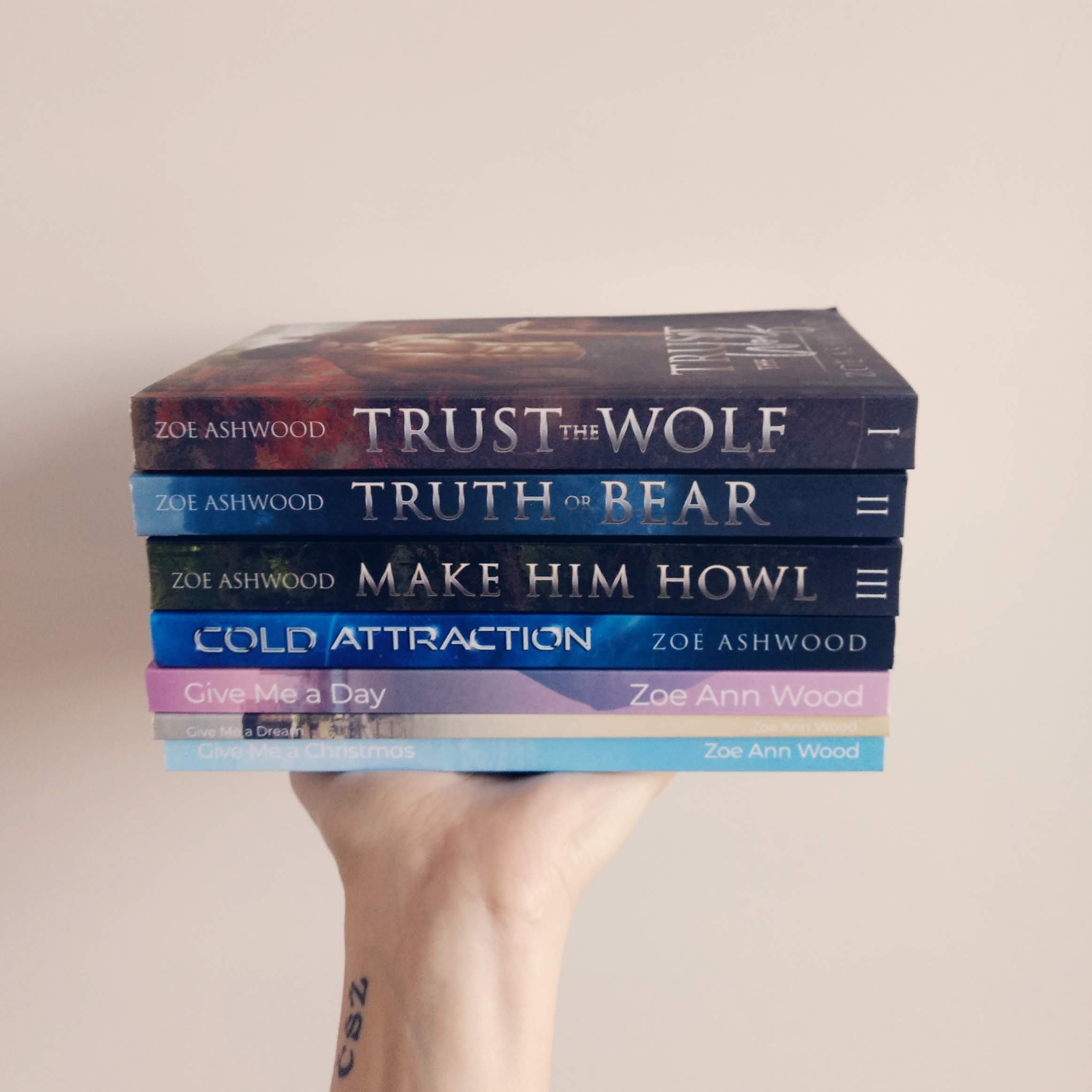A stack of paperback books by Zoe Ashwood and Zoe Ann Wood.